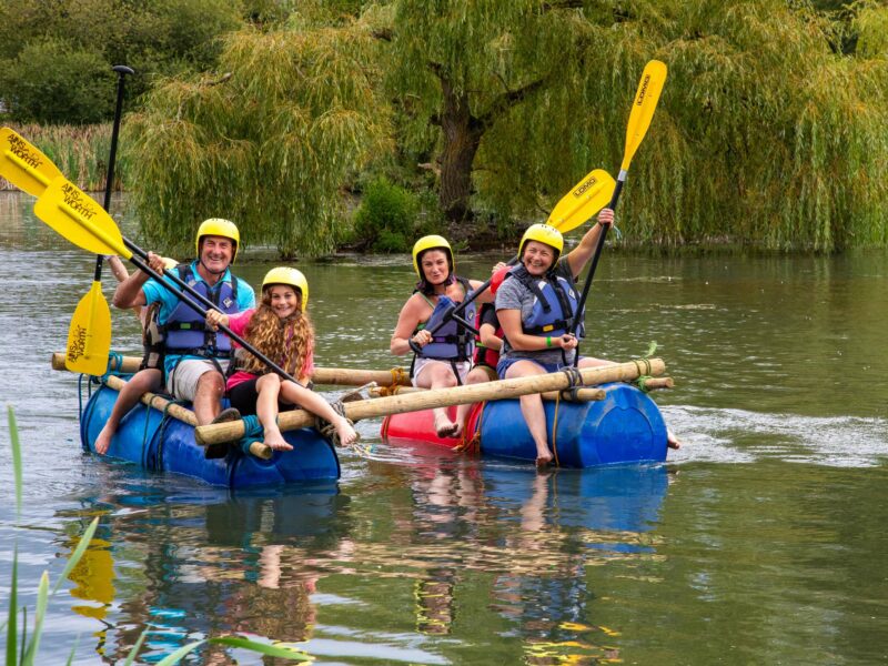 A family taking part in a rafting activity on the lake at Gone Wild festival