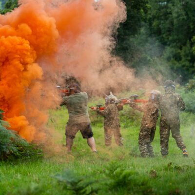 Four people taking part in a paintballing activity