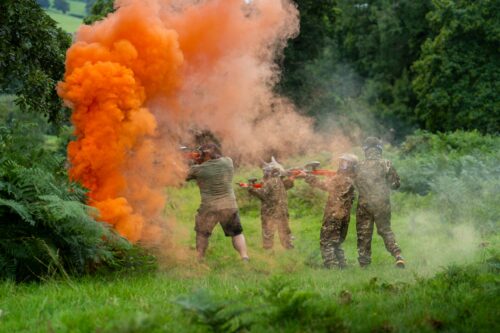Four people taking part in a paintballing activity