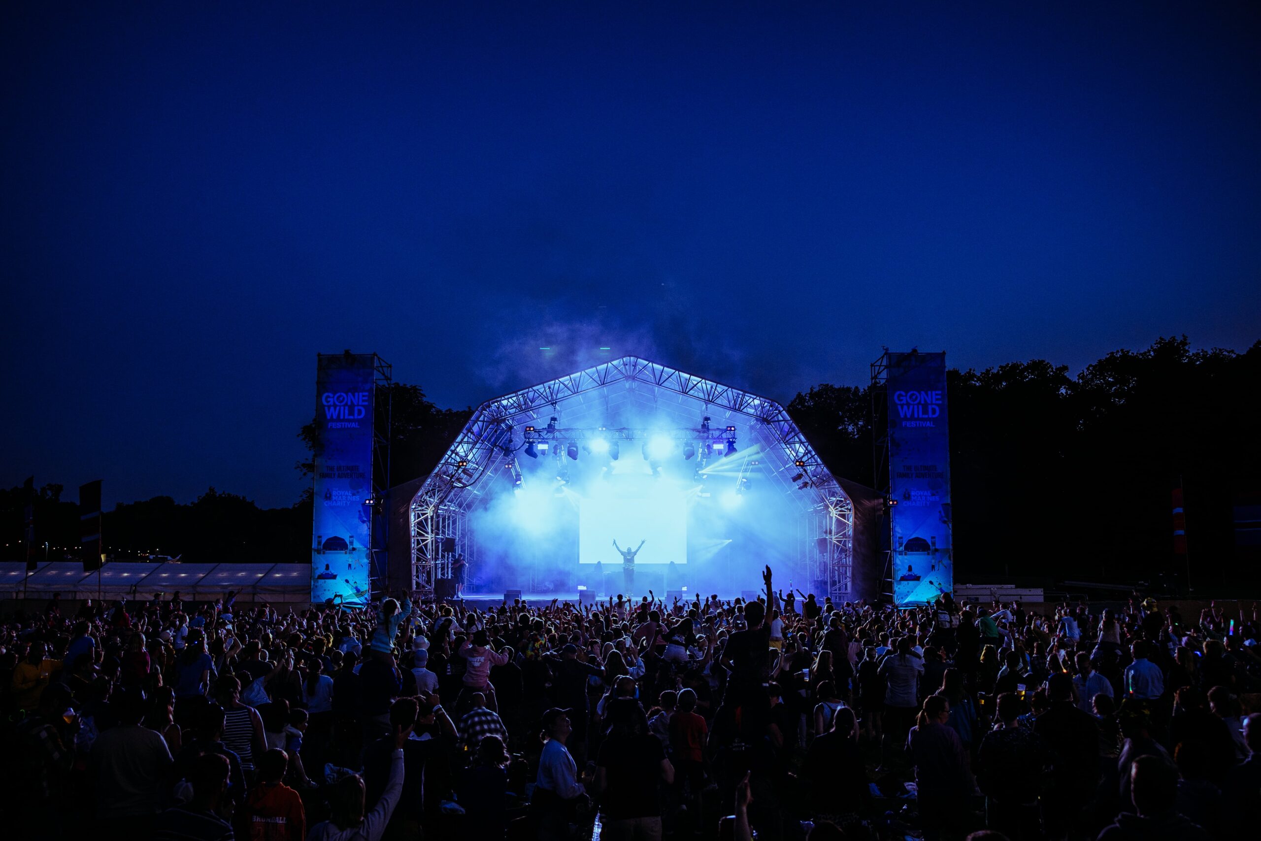 The main stage at Gone WiId Festival Norfolk lit up at night as the crowd watch a performance